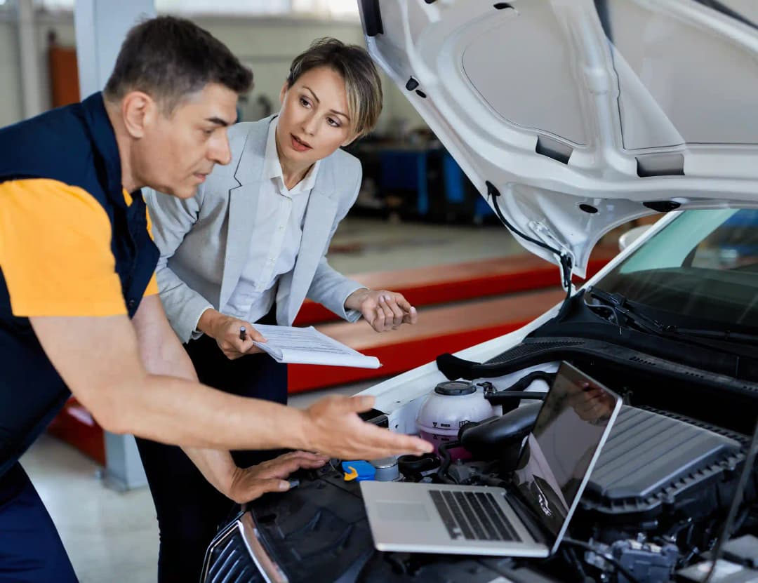 Insurance assessor and ADAS technician reviewing digital calibration report together in professional Melbourne workshop